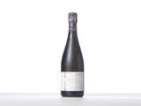 a bottle of wine sitting on top of a white table
