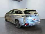the rear end of a silver car in a white room