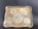 a silver tray with circles on it sitting on a table