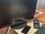 an image of a computer monitor and keyboard on a desk
