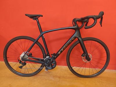 un vélo appuyé contre un mur rouge