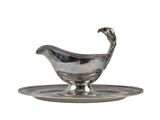 an antique silver plate with a saucer and saucer on it