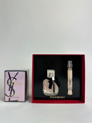 an image of a bottle of perfume next to a box of perfume