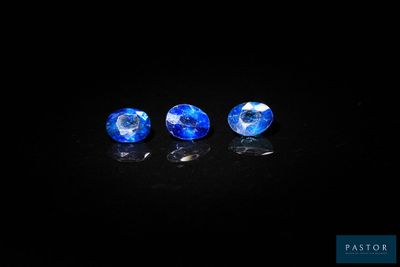 a pair of blue sapphires on a black background
