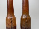 two vases that have been painted with trees on them
