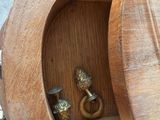 a wooden shelf with a small wooden object inside of it