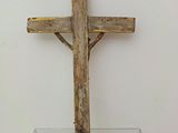 a wooden cross sitting on top of a glass table