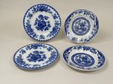 three blue and white plates with floral designs on them
