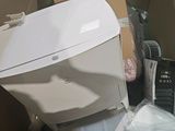 a white toilet sitting inside of a box in a room