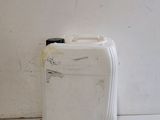 a white suitcase sitting next to a white wall