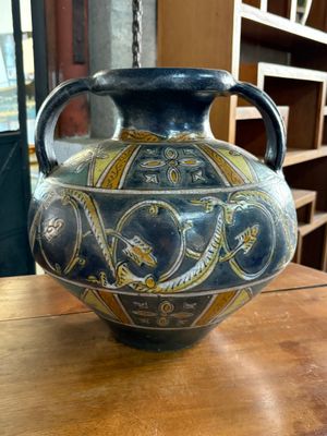 a blue vase sitting on a table in a room