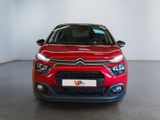the front of a red citrole parked in a white room