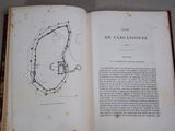 an open book with a drawing of a castle on it