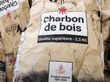bags of charcoal are stacked on top of each other in a pile