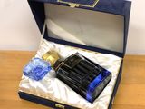 a bottle of perfume in a blue box on a table