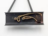 a metal object with a rope hanging from it ' s side