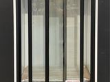 an image of a commercial display case with sliding doors on a pallet
