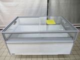 a glass display case with a yellow sticker on it