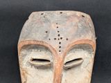 an image of a wooden mask on a black background