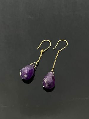 a pair of amethorate earrings on a black surface