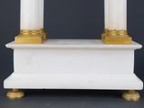 an image of a white and gold candle holder on a black background