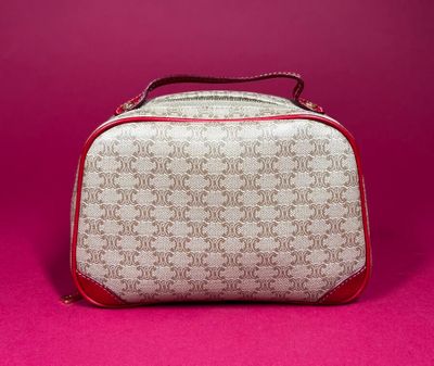 a close up of a white and red bag on a pink surface