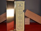 a metal box with a poem on it sitting on a table