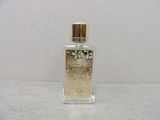 an image of a bottle of perfume on a white surface