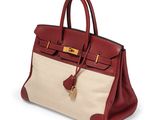 a red and beige leather handbag with gold hardware