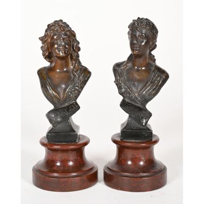 a pair of bronze busts of a woman and a man