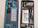the back of a cell phone with a broken battery and a broken battery