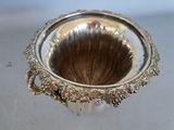 a silver vase that is sitting on a table