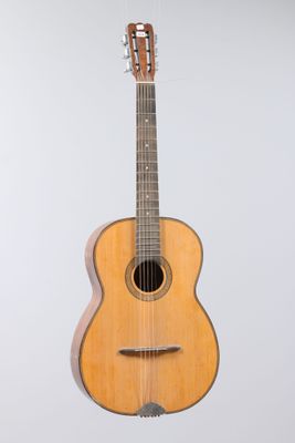 an image of a guitar hanging from a string on a wall