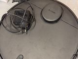 a robot that is sitting on the floor next to a box