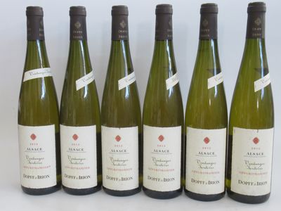 six bottles of wine are lined up in a row on a table