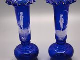 two blue vases that are sitting on a table