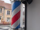 a red, white and blue striped pole attached to a wall