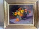 painting of flowers in a vase on a table in a gold frame