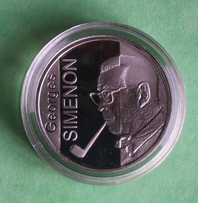 a close up of a coin with a picture of a man