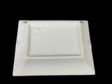 a white square plate with a square design on it