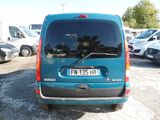 a blue van that is parked in a parking lot