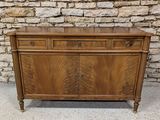 a wooden cabinet with two drawers and two doors