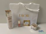 dior skin care products displayed on a white table with a white bag