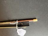 a wooden stick with a tag attached to it on a table