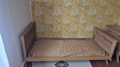 a bed that is in a room with a rug on the floor
