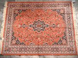 an orange and black rug with a medallion design on it