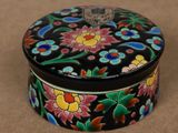 a close up of a black box with colorful flowers on it