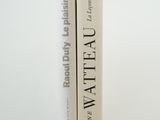 two books sitting on top of each other on a white surface