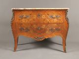 an antique chest of drawers with a marble top