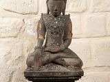 statue of a woman sitting in a lotus position on a black table